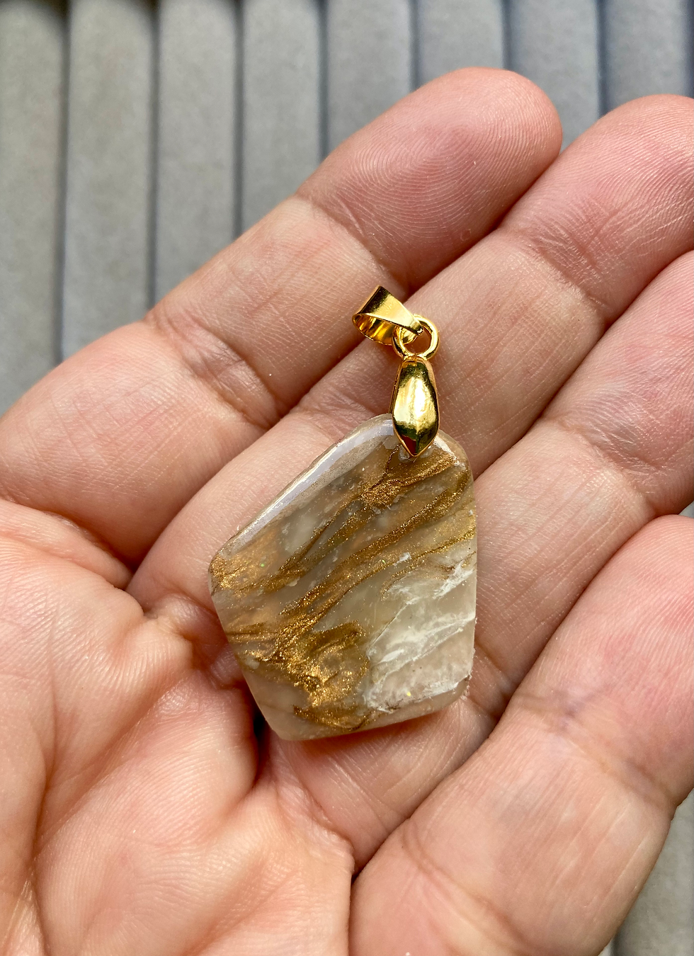 Thumbnail: Marbled bronze and white shield pendant on gold plated fittings