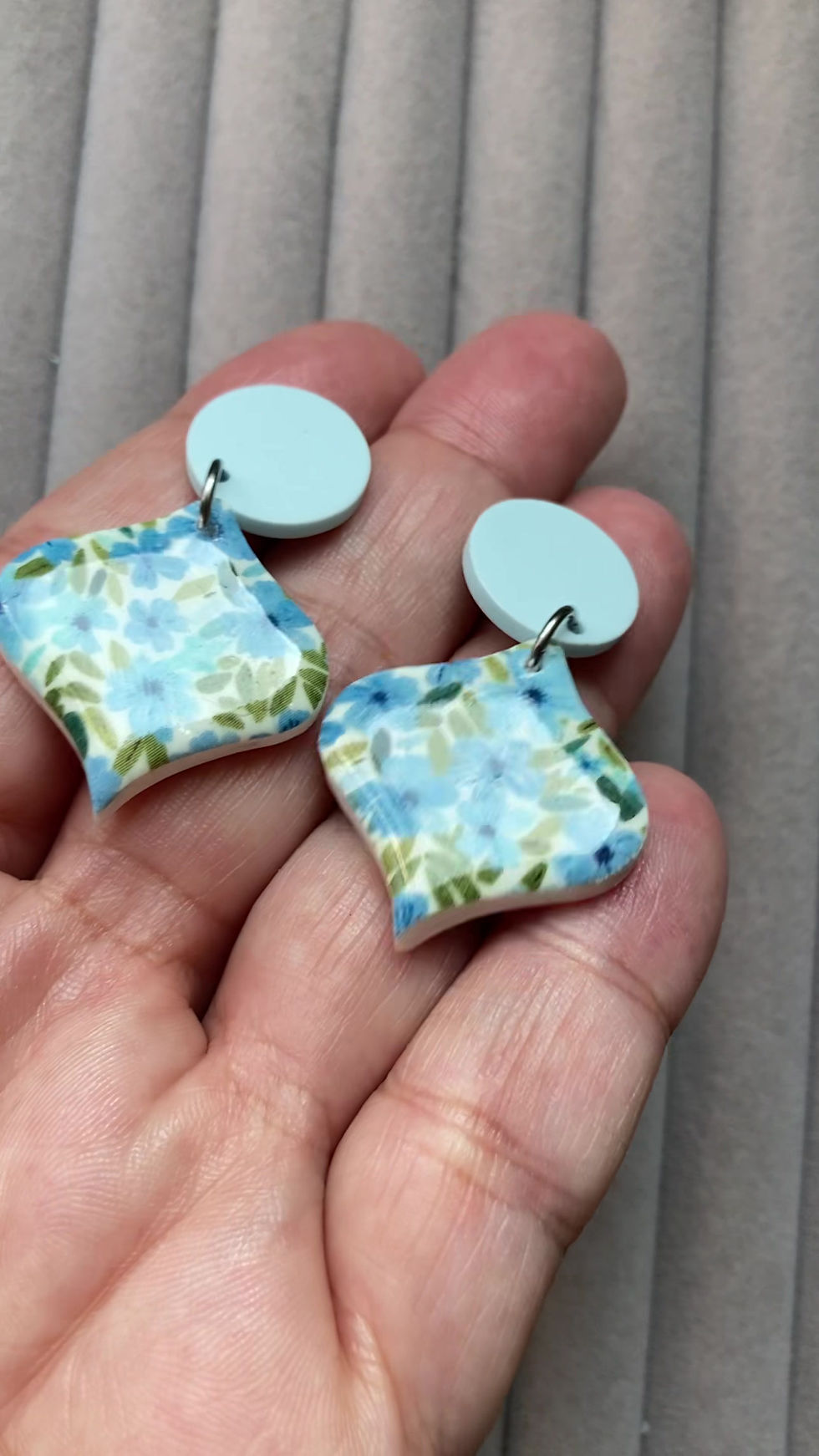 Thumbnail: Light blue and white flowers Emporio Prints earrings on light blue acrylic studs