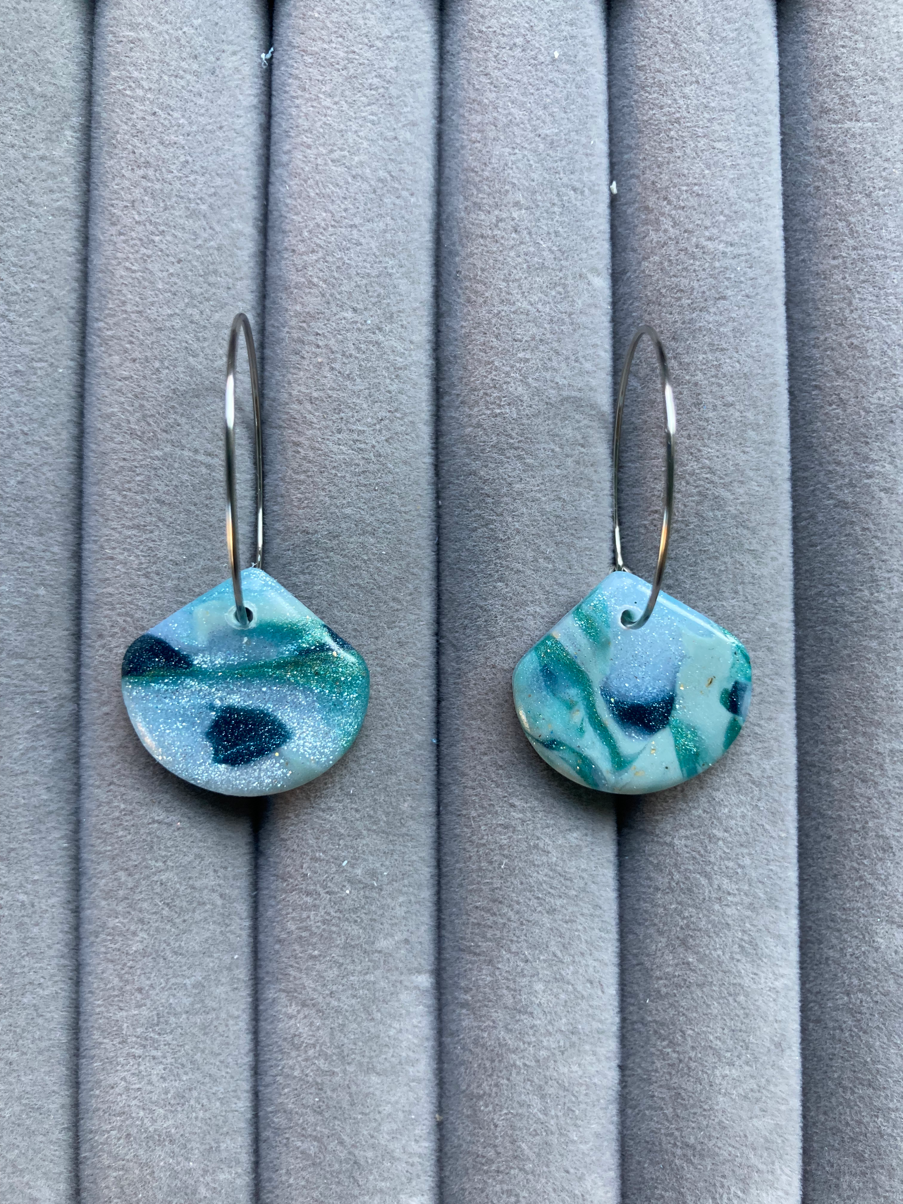 Blue and white marbled fan earrings on medium hoops