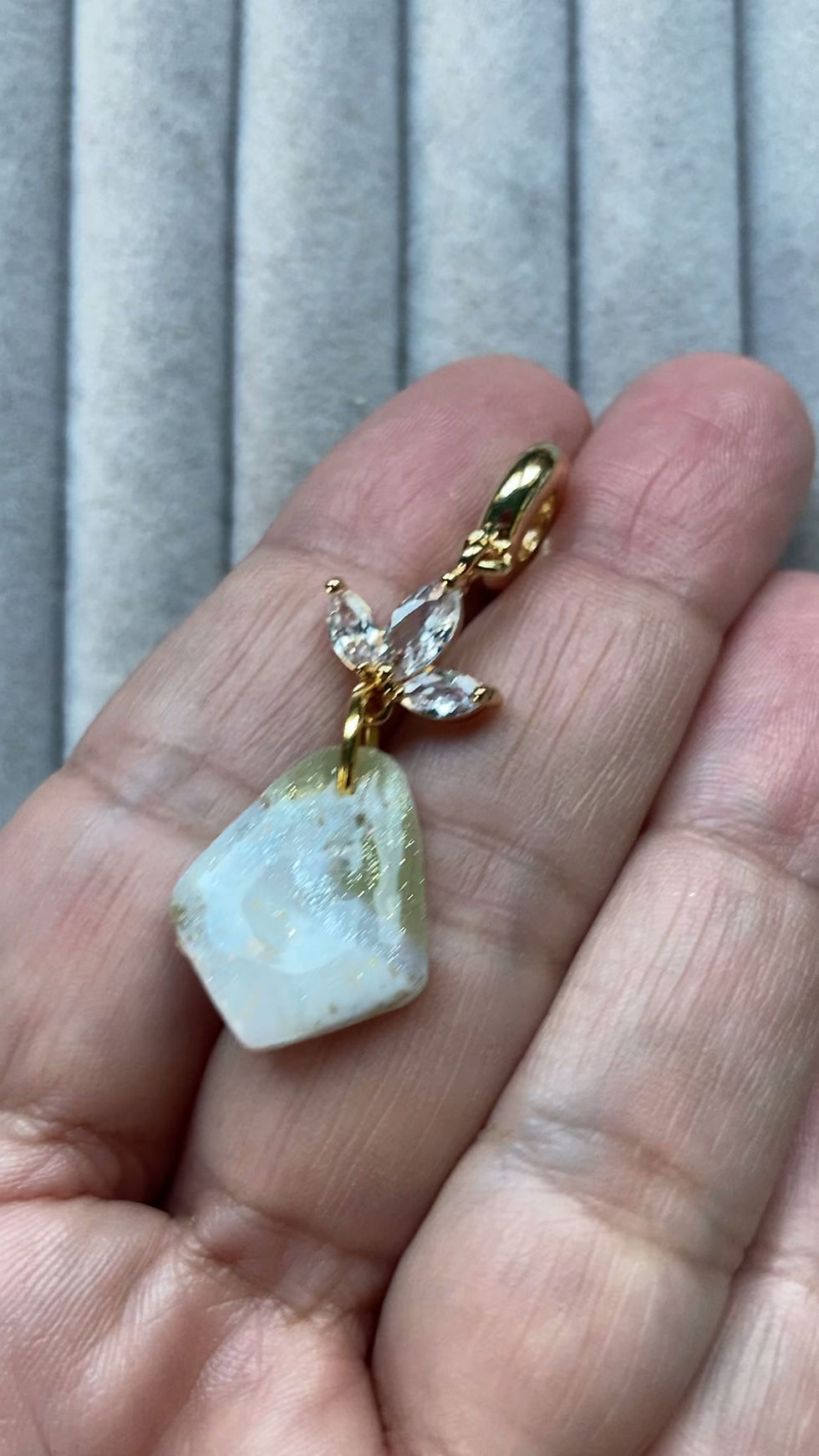 Thumbnail: Sparkly gold and white pendant with flower crystals on gold plated chain