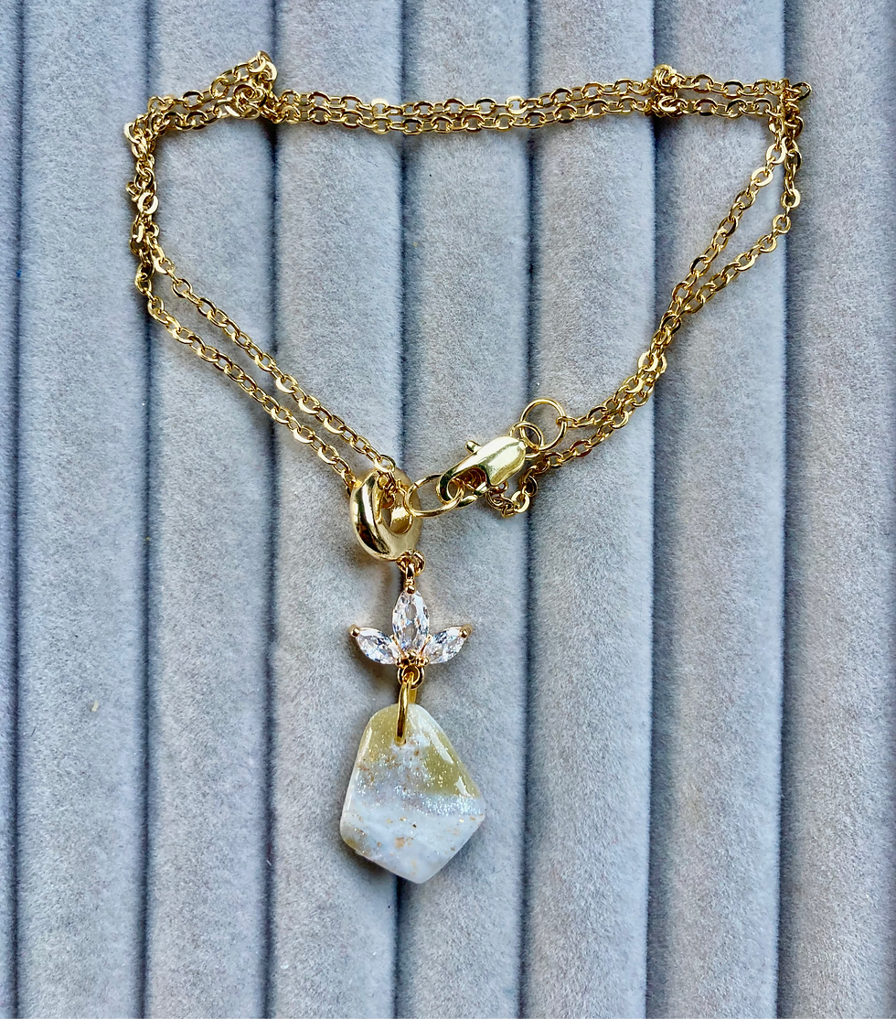 Sparkly gold and white pendant with flower crystals on gold plated chain