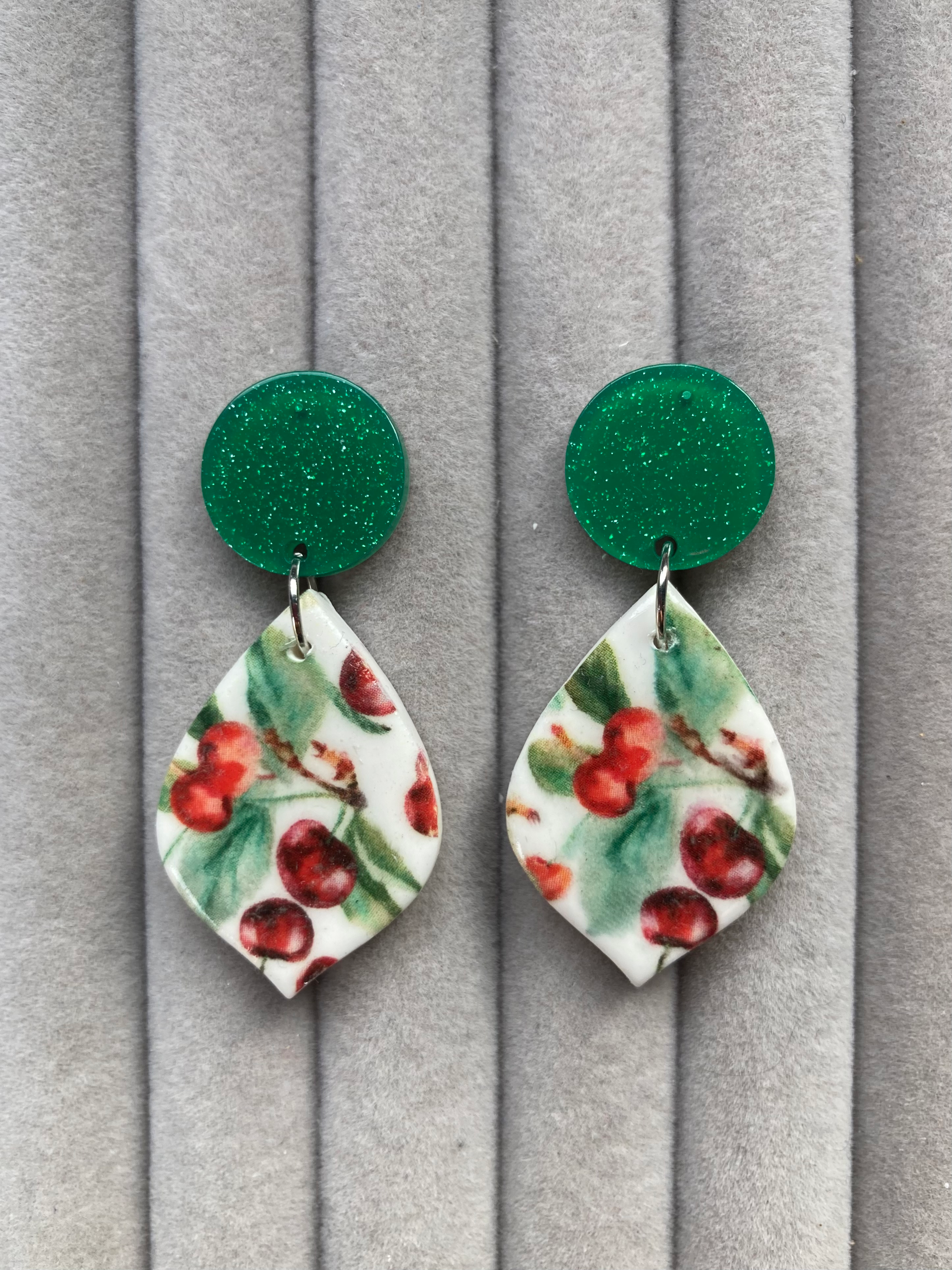Large red cherries earrings on sparkly green acrylic and silver studs