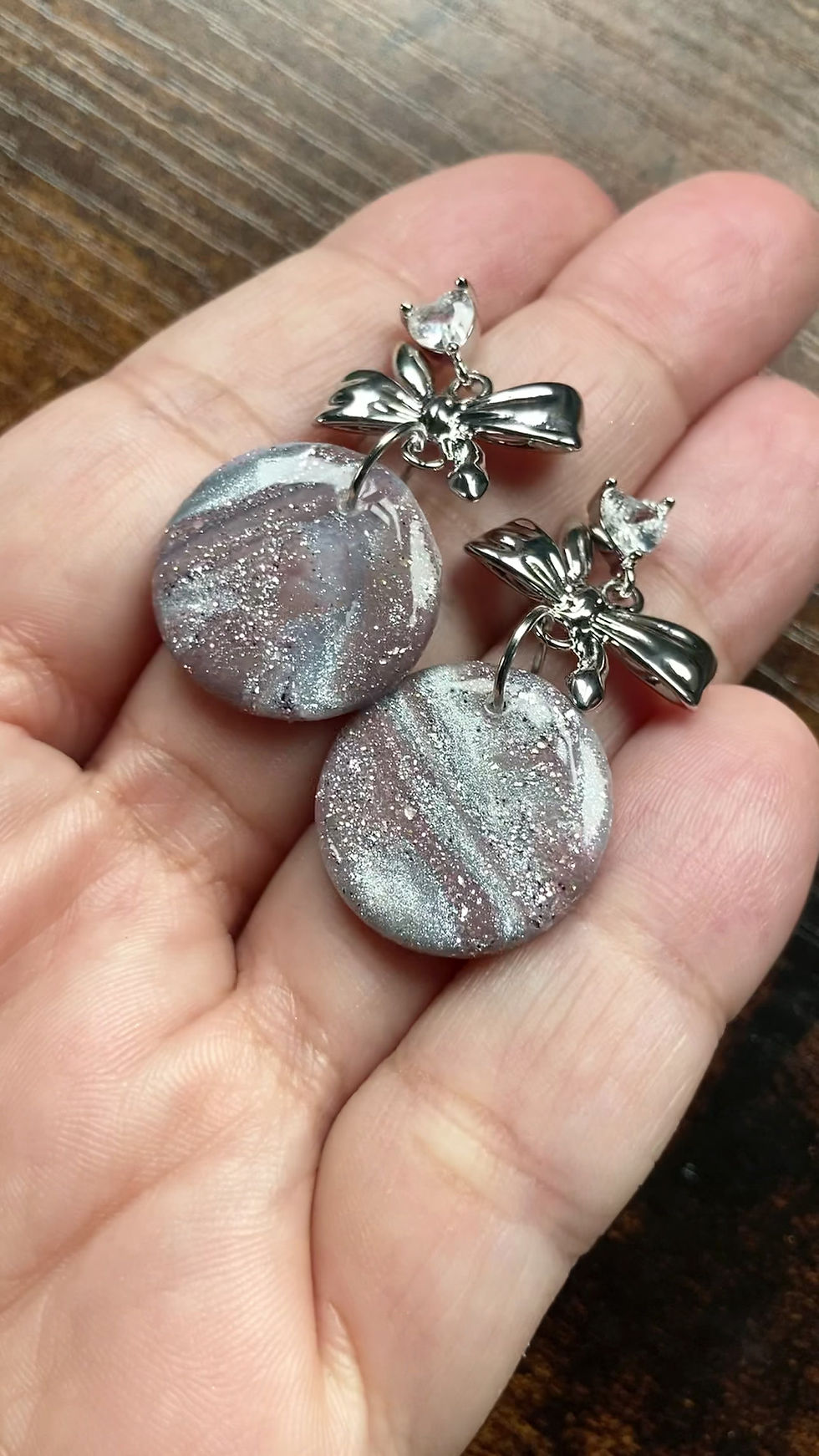 Thumbnail: Sparkly silver and antique mauve earrings on sparkly bow studs