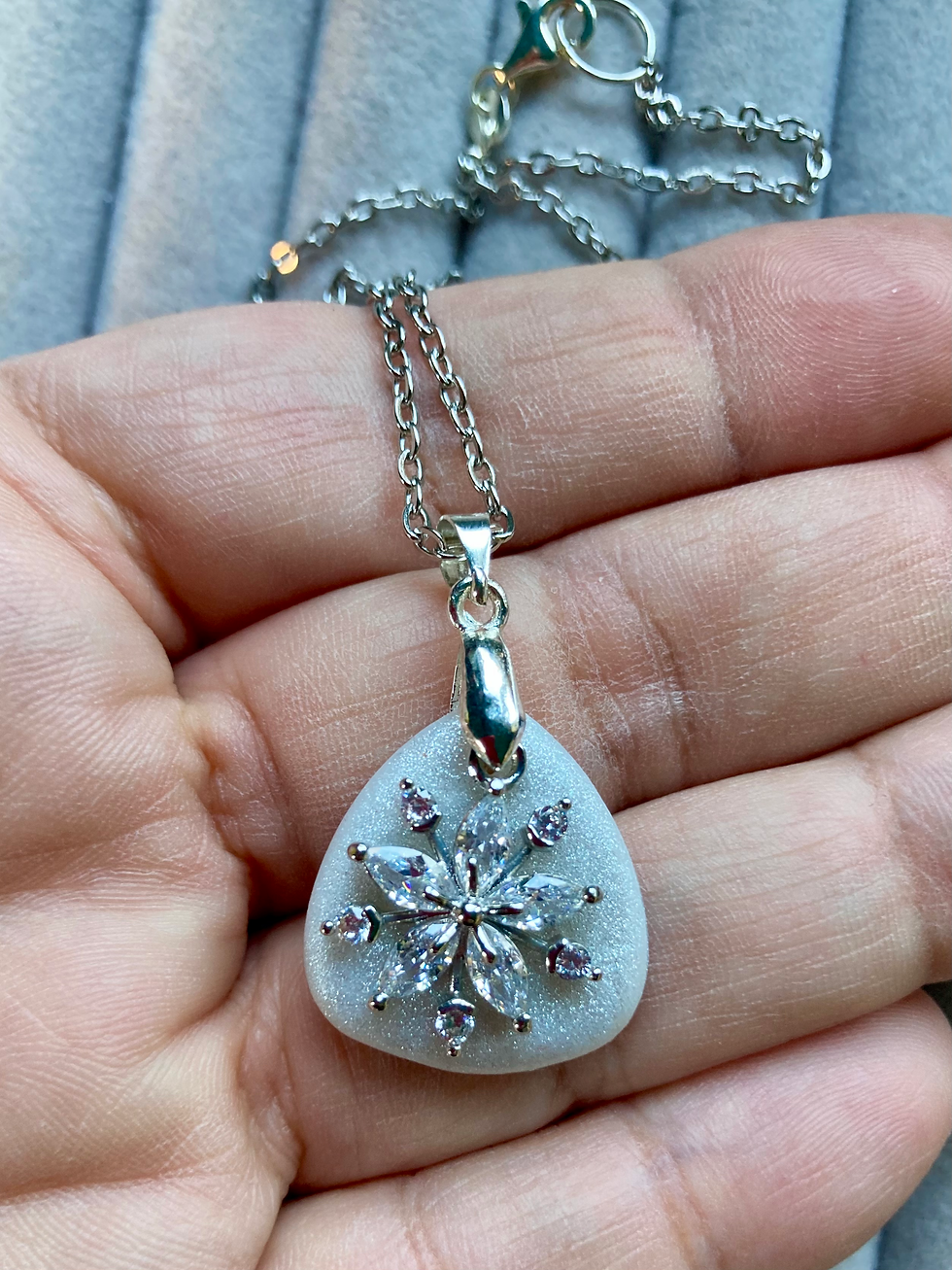 Thumbnail: Shimmery white pendant with crystal snowflake on a stainless steel chain