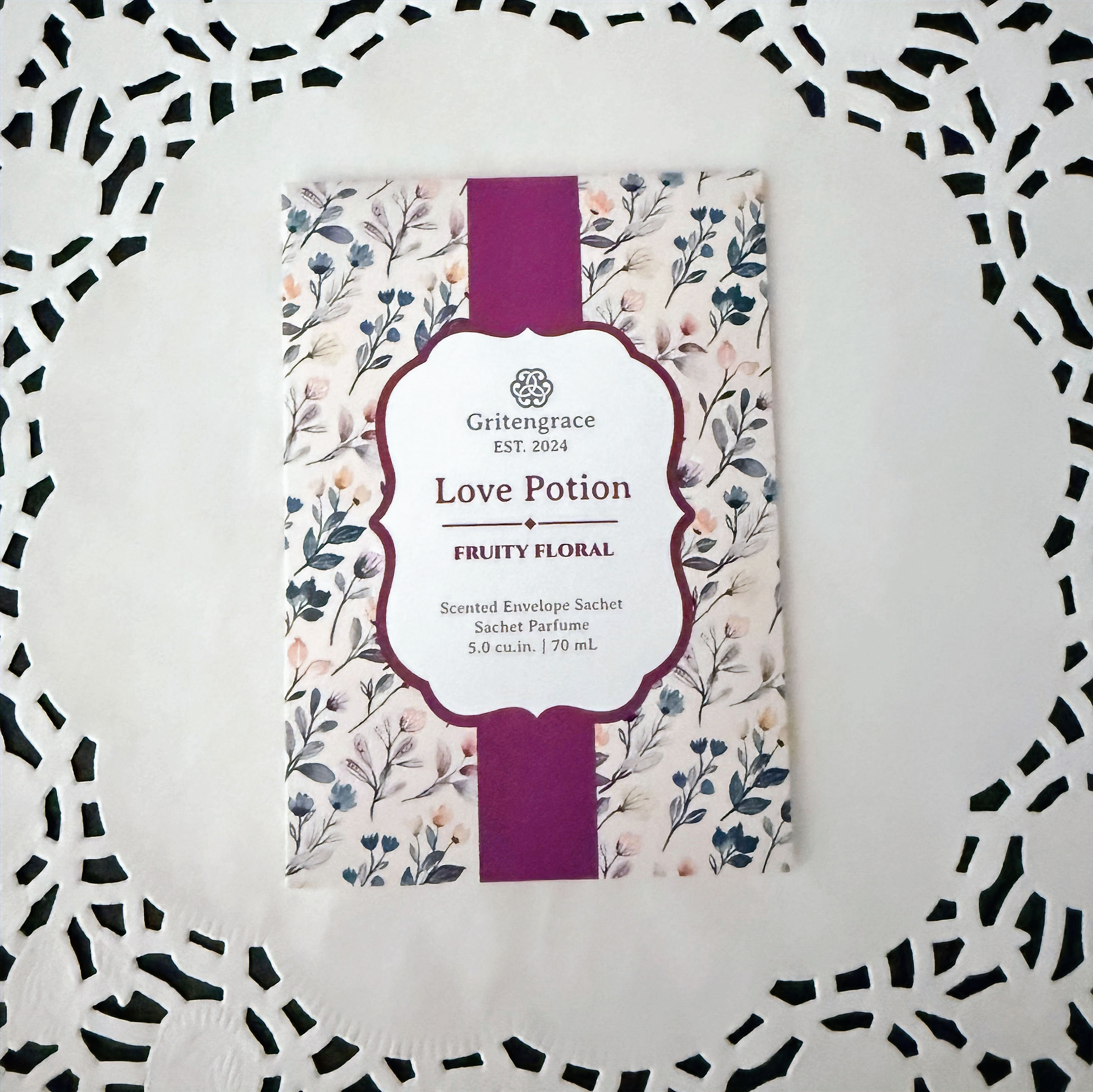 love potion scented sachet laying on a doily