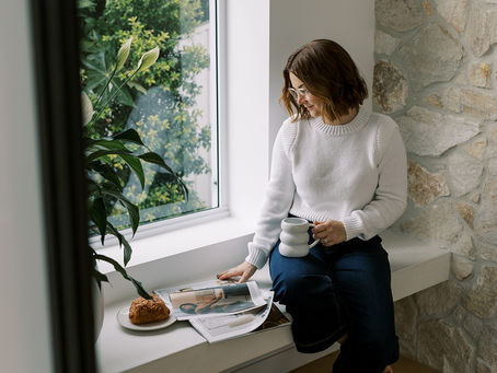 an interior designer having a coffee sitting in a window seat