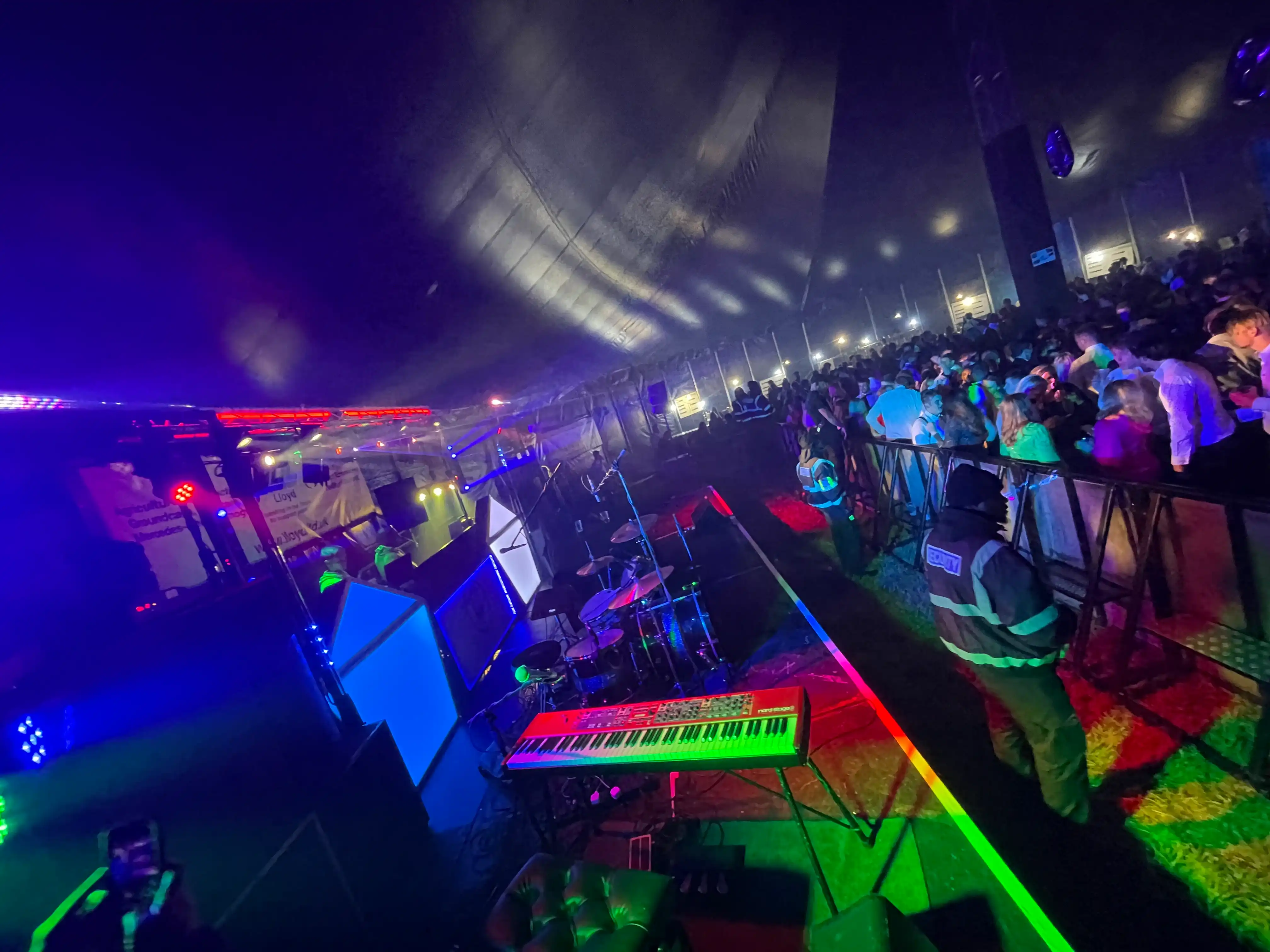 Inside of bigtop with illuminated disco on stage