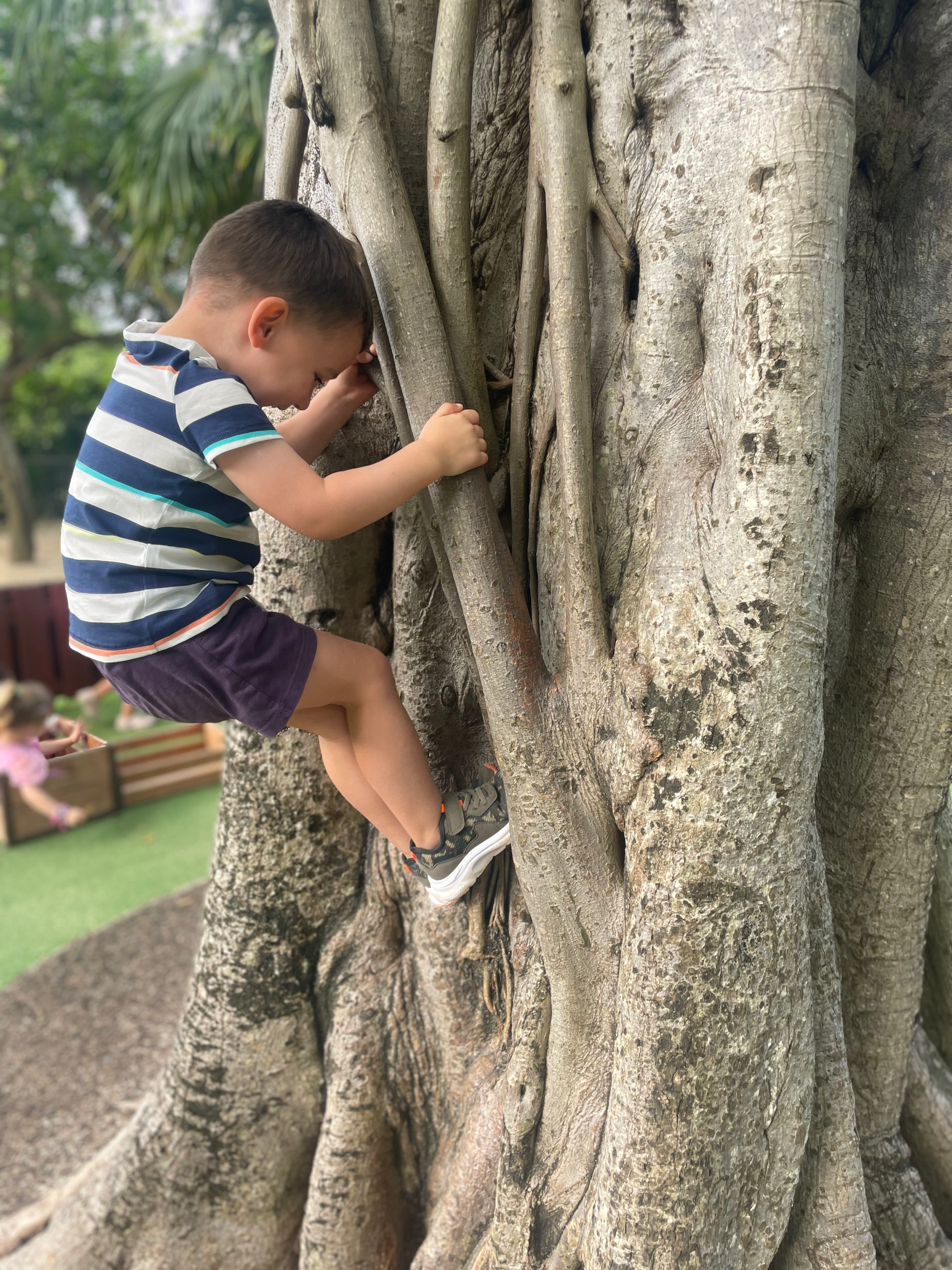 Child exploring outdoors with binoculars