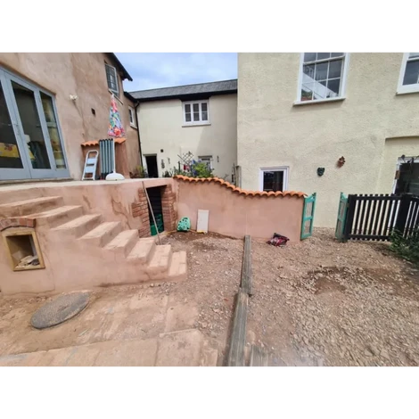 Raised concrete platform project with indian sandstone slabs installed.
