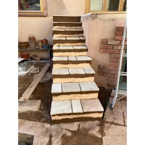 Front view of Raised concrete platform with indian sandstone slabs.