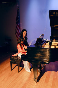 Student learning piano performance skills at Gala Piano Studio