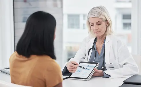 woman-doctor-showing-patient-tablet-in-office-2026-03-25-05-50-54-utc.webp