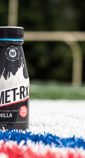 MET-Rx Vanilla protein drink bottle on field