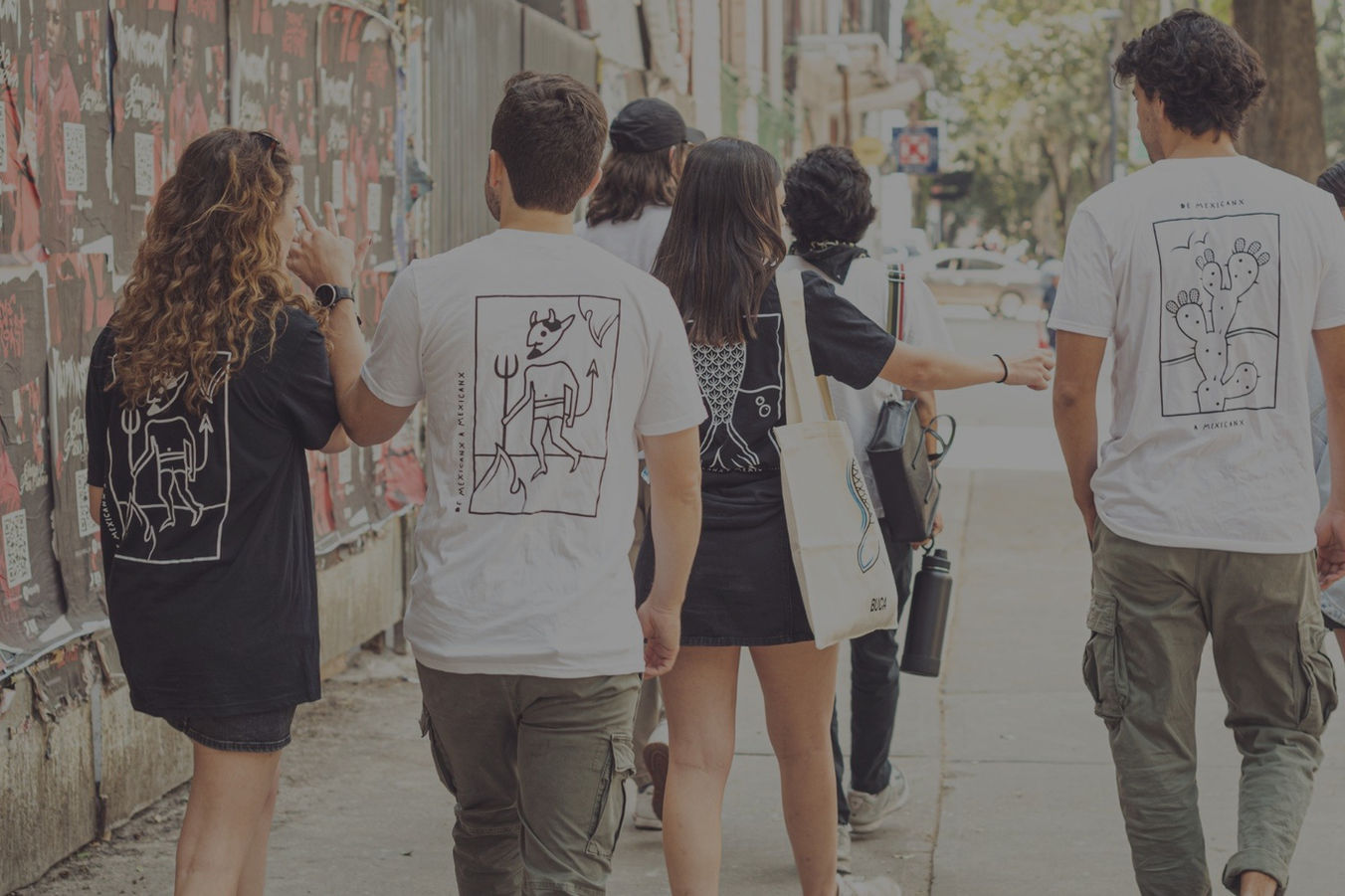 Friends walking wearing BUCA t-shirts