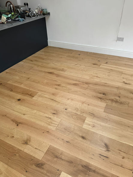 Engineered wood flooring fitted around kitchen units in Catford by Alba Flooring