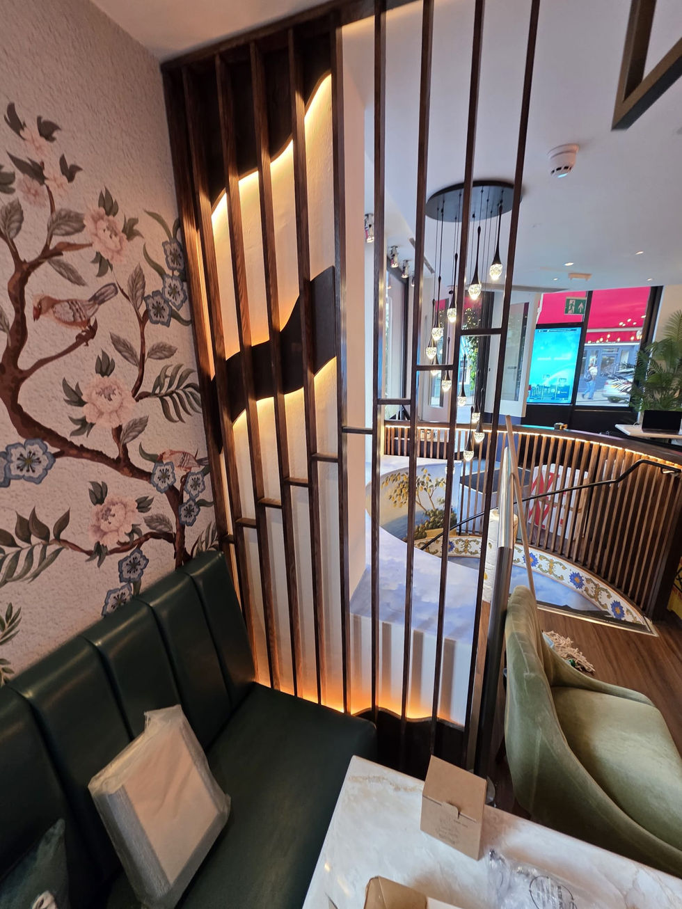 Curved staircase with custom timber balustrade and decorative mural in restaurant fit out