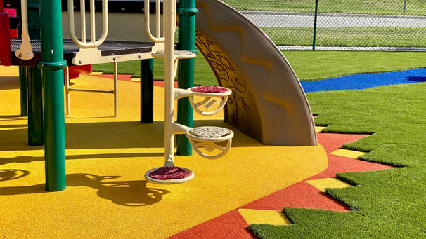 playground with slide rubber flooring and artificial grass