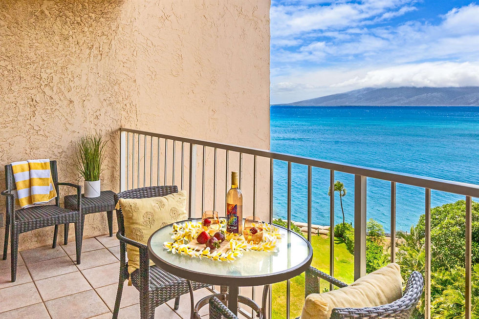 Condo balcony table with drinks overlooking the blue Pacific Ocean.
