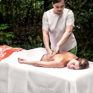 Relaxing massage outdoors, tranquil spa setting