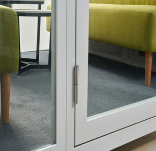 Close-up of the heavy-duty acoustic glass door handle and locking mechanism.