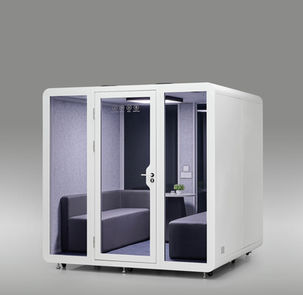 Three-quarter exterior view of a white with tinted glass, 8-person office privacy pod.