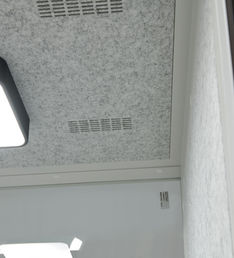 Interior view of the upper ventilation slats and acoustic ceiling.