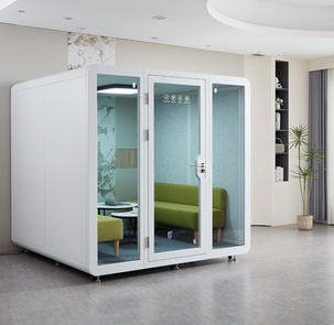 Interior view of HexPod Pro showing green sofa seating and integrated table.