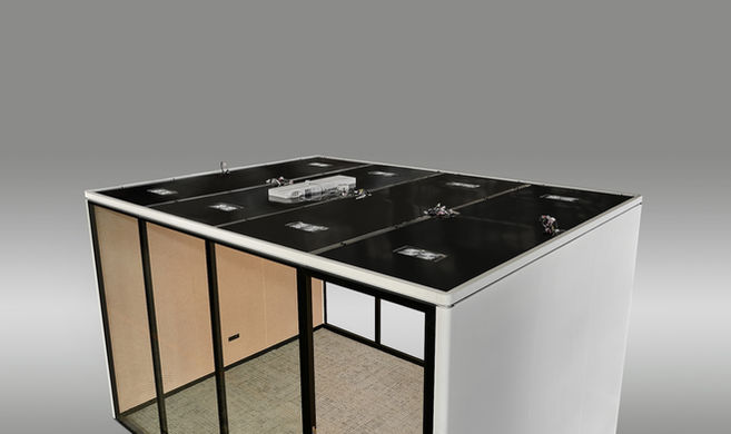 Exterior bird's eye view of a white executive office pod with black trim.