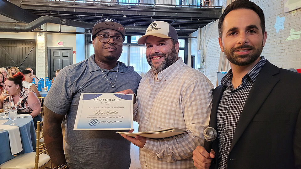 Two men holding a certificate, smiling. BGCCA Announces the Departure of CEO Justin Reuter.