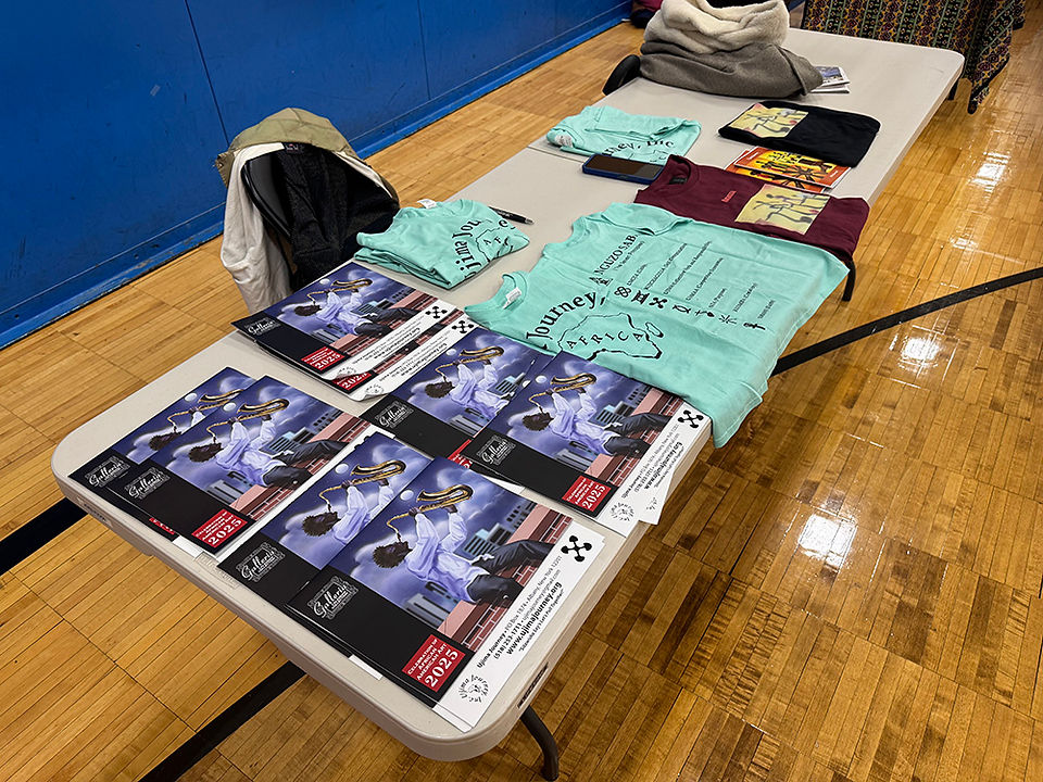 Table with promotional materials, t-shirts and informational brochures for an event BGCCA