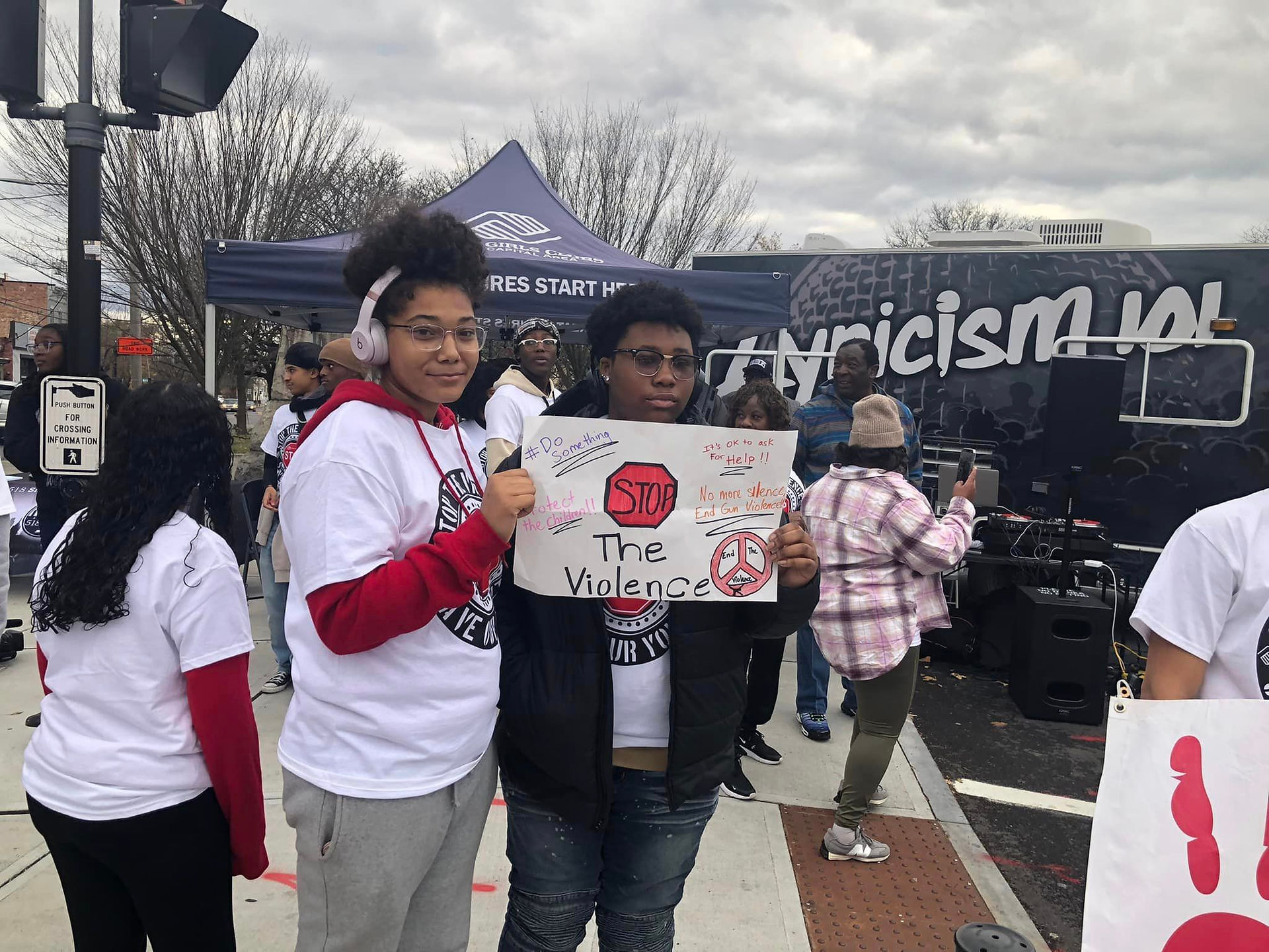 Two people holding a sign that says Stop the Violence, BGCCA event.