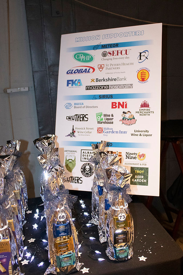 Sponsor logos and gift bags at gala event for BGCCA. 2021 Club Gala