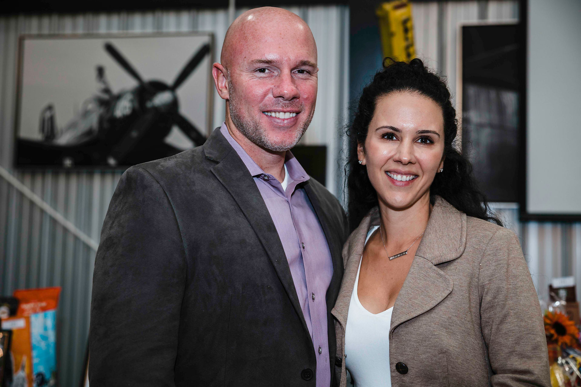 Smiling couple posing together for a photograph, BGCCA event setting background.