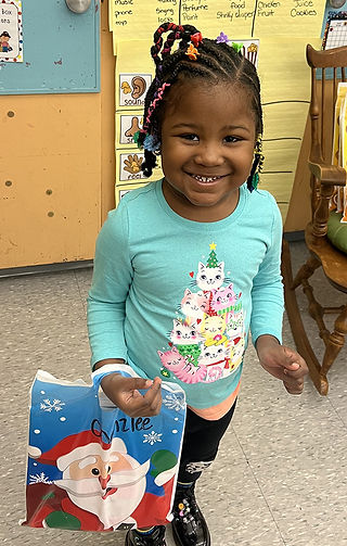 Smiling girl holding a gift with 