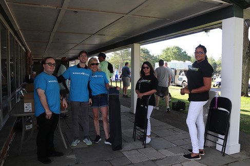 Group of people at an event, BGCCA 2023 Golf Tournament, sunny day outside.