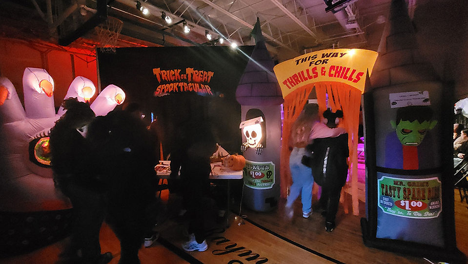 Entrance to Trick-or-Treat Spectacular with a sign reading Thrills & Chills. BGCCA