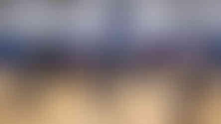 Boys and Girls Club members stand in a gym near chairs, looking towards a scoreboard.