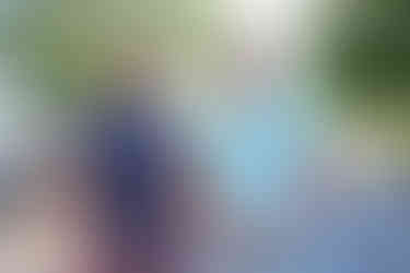 Two men smiling, looking at the camera, outdoors. BGCCA event, summer day.