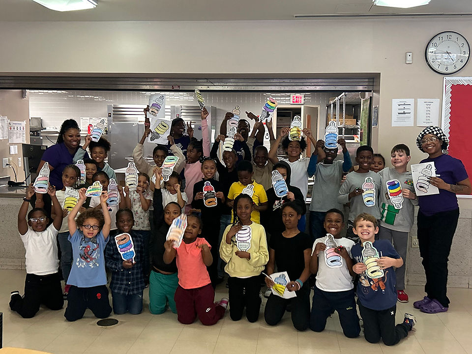 Group of children holding up papers, smiling. A look back at 2022! BGCCA