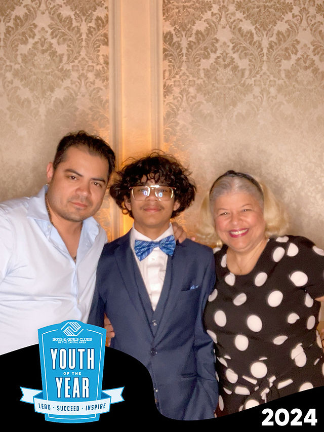 Three people pose with "Youth Year" banner 2024, BGCCA members smiling together.