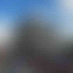 Large building with a crowd of people on a beautiful day BGCCA