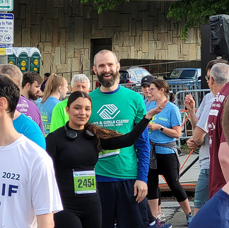 Smiling couple at a Boys & Girls Club event, 2451 race bibs, BGCCA