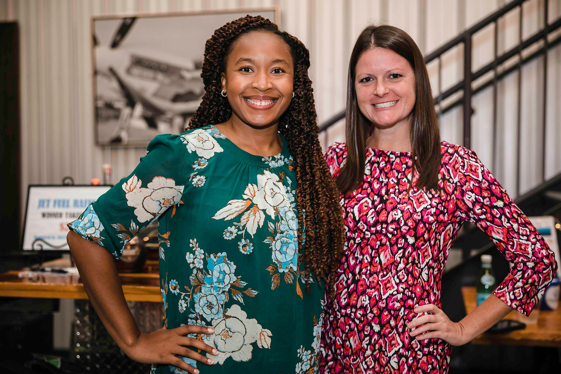 Two smiling women posing together with a vintage background, BGCCA.