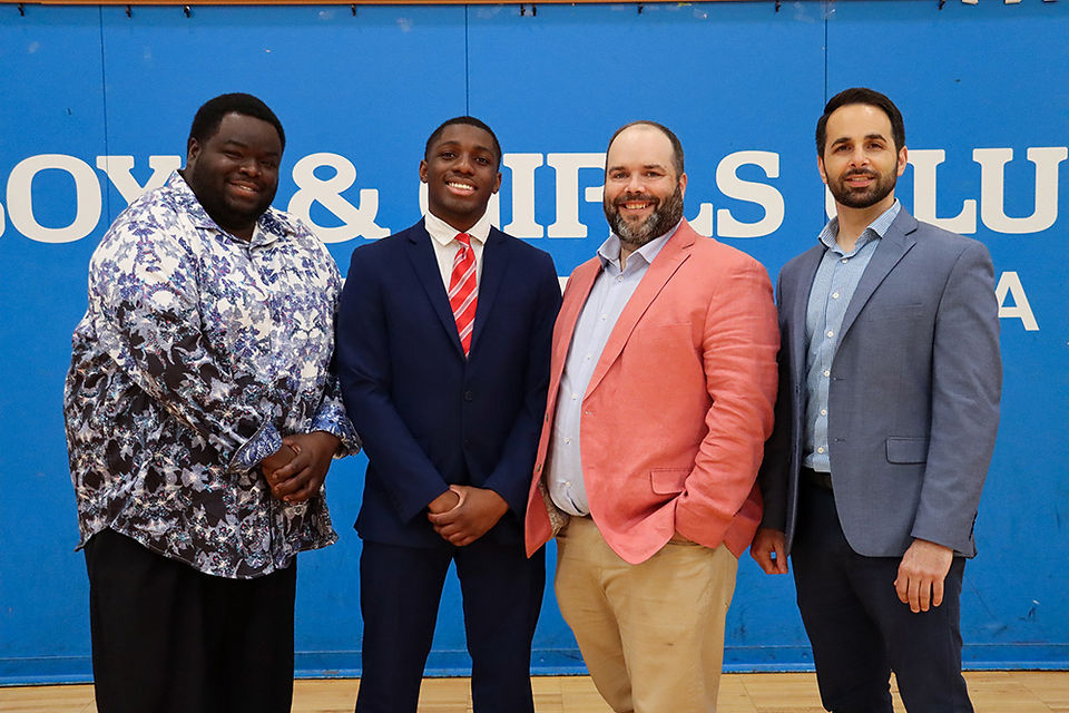 Group of men posing in front of Boys & Girls Club logo, CEO Transition, BGCCA