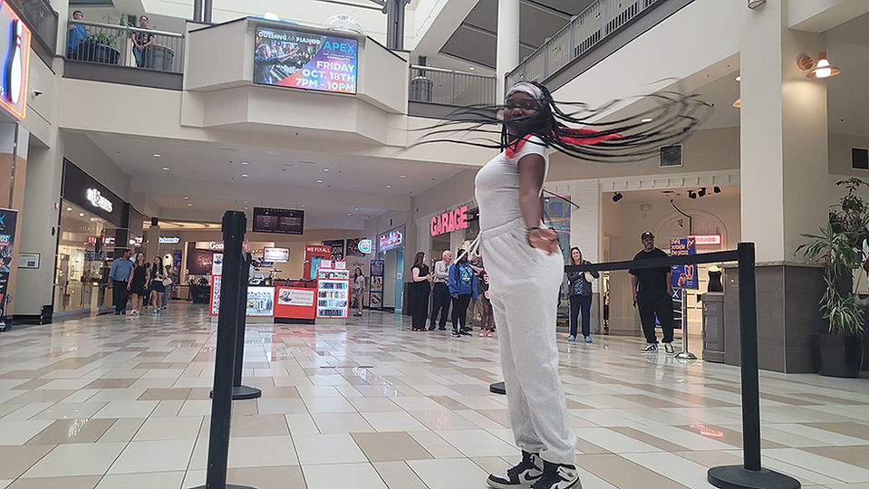 Woman poses in a mall with 