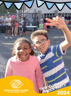Smiling children posing, boy with peace sign, sunny day, BGCCA fun, outdoors.