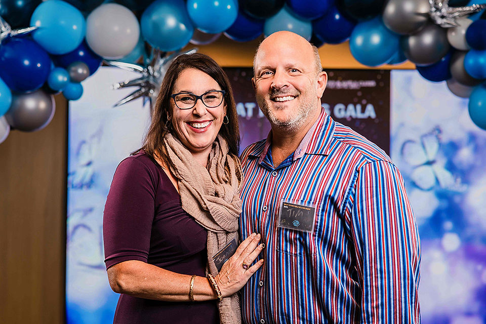 Smiling couple at the Gala event, with balloons and visible text BGCCA.