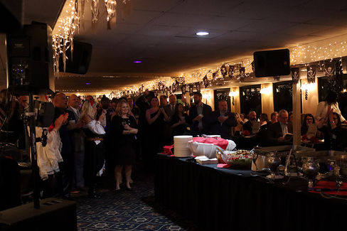 Group applauds at 2022 Gala: Pirate Cruise, event with BGCCA, people celebrating.