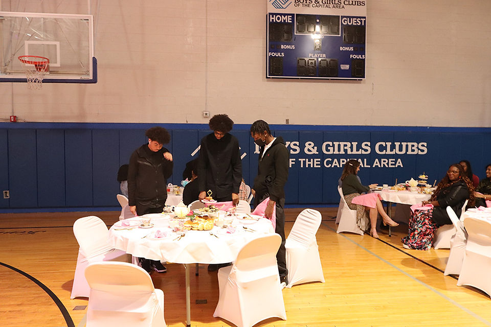 Guests around tables with tea, Boys & Girls Club in background, BGCCA 2024 Women's Tea
