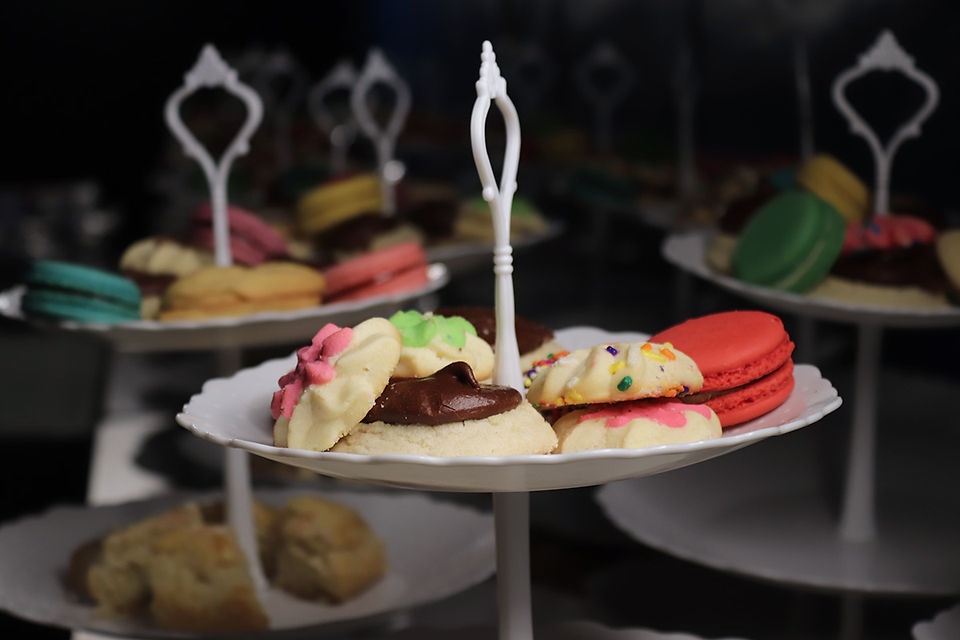 Cookies and macarons on trays. Various colors and flavors are displayed BGCCA
